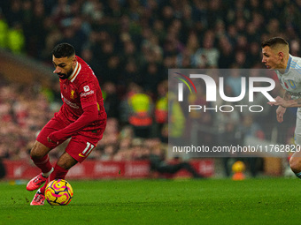 Liverpool's Mohamed Salah is in action with Aston Villa's Lucas Digne during the Premier League match between Liverpool and Aston Villa at A...