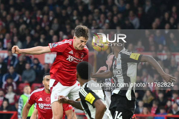 Ryan Yates of Nottingham Forest heads the ball under pressure from Alexander Isak of Newcastle United during the Premier League match betwee...