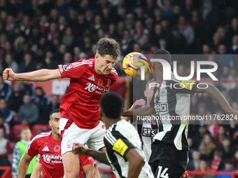 Ryan Yates of Nottingham Forest heads the ball under pressure from Alexander Isak of Newcastle United during the Premier League match betwee...