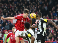 Ryan Yates of Nottingham Forest heads the ball under pressure from Alexander Isak of Newcastle United during the Premier League match betwee...