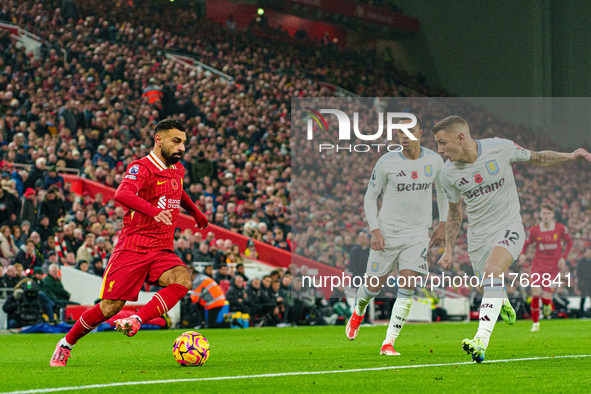 Liverpool's Mohamed Salah competes with Aston Villa's Jacob Ramsey and Lucas Digne during the Premier League match between Liverpool and Ast...