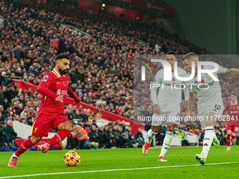 Liverpool's Mohamed Salah competes with Aston Villa's Jacob Ramsey and Lucas Digne during the Premier League match between Liverpool and Ast...