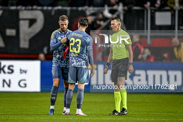 AFC Ajax Amsterdam midfielder Jordan Henderson, AFC Ajax Amsterdam forward Steven Berghuis, and referee Allard Lindhout participate in a mat...