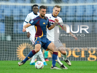 Bryan Cristante of AS Roma and Tommaso Pobega of Bologna FC compete for the ball during the Serie A Enilive match between AS Roma and Bologn...