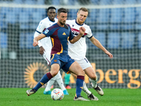 Bryan Cristante of AS Roma and Tommaso Pobega of Bologna FC compete for the ball during the Serie A Enilive match between AS Roma and Bologn...