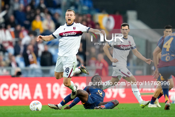 Tommaso Pobega of Bologna FC and Manu Kone' of AS Roma compete for the ball during the Serie A Enilive match between AS Roma and Bologna FC...