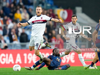 Tommaso Pobega of Bologna FC and Manu Kone' of AS Roma compete for the ball during the Serie A Enilive match between AS Roma and Bologna FC...