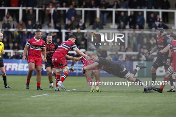 Philip van der Walt of Newcastle Falcons tackles Telusa Veainu of Doncaster Knights during the Premiership Cup Pool A match between Newcastl...