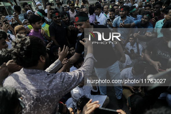 Hasnat Abdulla, coordinator of the Anti Discrimination Student Movement, shakes hands with a supporter in Dhaka, Bangladesh, on November 10,...