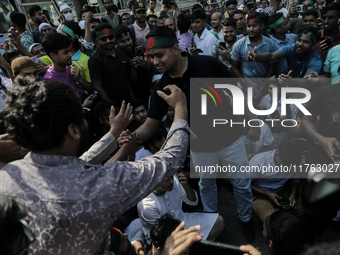 Hasnat Abdulla, coordinator of the Anti Discrimination Student Movement, shakes hands with a supporter in Dhaka, Bangladesh, on November 10,...