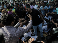 Hasnat Abdulla, coordinator of the Anti Discrimination Student Movement, shakes hands with a supporter in Dhaka, Bangladesh, on November 10,...