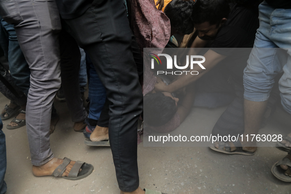 A Pro Awami League supporter is beaten by students from anti-discrimination movements in Dhaka, Bangladesh, on November 10, 2024. 