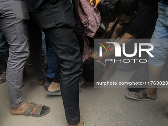 A Pro Awami League supporter is beaten by students from anti-discrimination movements in Dhaka, Bangladesh, on November 10, 2024. (