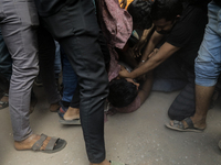 A Pro Awami League supporter is beaten by students from anti-discrimination movements in Dhaka, Bangladesh, on November 10, 2024. (