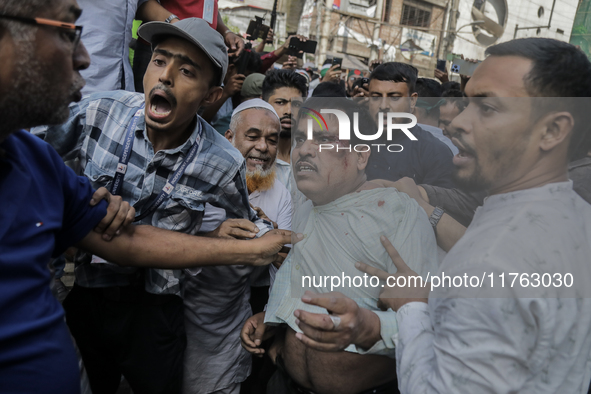 A Pro Awami League supporter is beaten by students from anti-discrimination movements in Dhaka, Bangladesh, on November 10, 2024. 