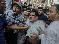 A Pro Awami League supporter is beaten by students from anti-discrimination movements in Dhaka, Bangladesh, on November 10, 2024. (