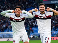 Riccardo Orsolini of Bologna FC celebrates with Santiago Castro after scoring second goal during the Serie A Enilive match between AS Roma a...