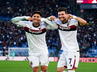 Riccardo Orsolini of Bologna FC celebrates with Santiago Castro after scoring second goal during the Serie A Enilive match between AS Roma a...