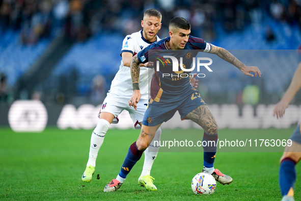 Jesper Karlsson of Bologna FC and Gianluca Mancini of AS Roma compete for the ball during the Serie A Enilive match between AS Roma and Bolo...