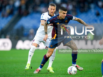 Jesper Karlsson of Bologna FC and Gianluca Mancini of AS Roma compete for the ball during the Serie A Enilive match between AS Roma and Bolo...