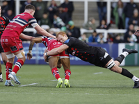 Philip van der Walt of Newcastle Falcons tackles Telusa Veainu of Doncaster Knights during the Premiership Cup Pool A match between Newcastl...