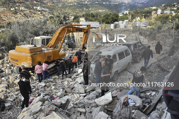 Rescuers search for survivors at the site of an Israeli airstrike that targets the village of Almat north of Beirut, Lebanon, on November 10...