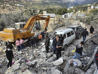 Rescuers search for survivors at the site of an Israeli airstrike that targets the village of Almat north of Beirut, Lebanon, on November 10...