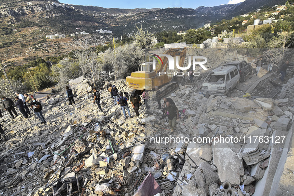 Rescuers search for survivors at the site of an Israeli airstrike that targets the village of Almat north of Beirut, Lebanon, on November 10...