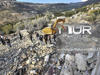 Rescuers search for survivors at the site of an Israeli airstrike that targets the village of Almat north of Beirut, Lebanon, on November 10...