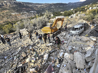 Rescuers search for survivors at the site of an Israeli airstrike that targets the village of Almat north of Beirut, Lebanon, on November 10...