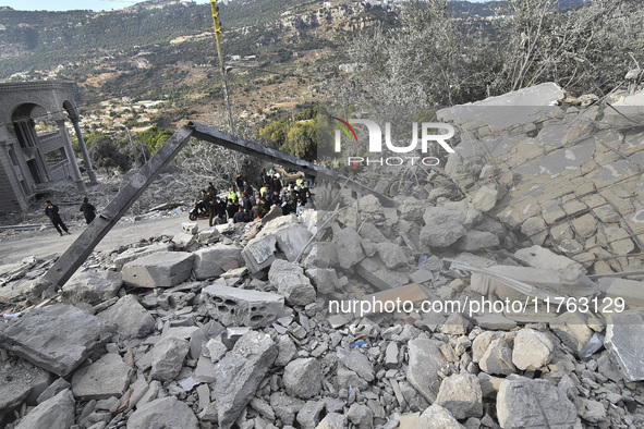 Rescuers search for survivors at the site of an Israeli airstrike that targets the village of Almat north of Beirut, Lebanon, on November 10...