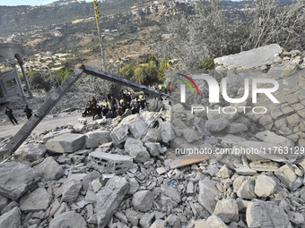 Rescuers search for survivors at the site of an Israeli airstrike that targets the village of Almat north of Beirut, Lebanon, on November 10...