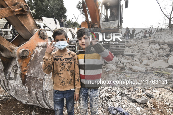 Rescuers search for survivors at the site of an Israeli airstrike that targets the village of Almat north of Beirut, Lebanon, on November 10...