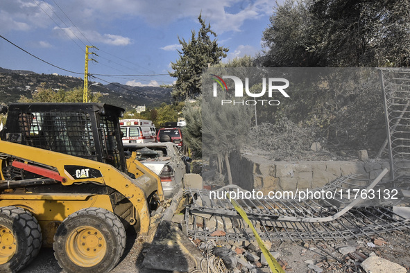 Rescuers search for survivors at the site of an Israeli airstrike that targets the village of Almat north of Beirut, Lebanon, on November 10...