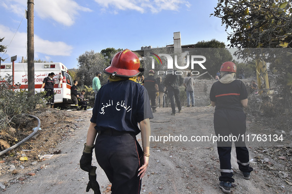 Rescuers search for survivors at the site of an Israeli airstrike that targets the village of Almat north of Beirut, Lebanon, on November 10...