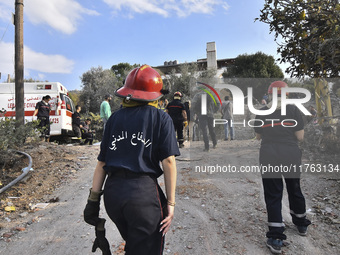 Rescuers search for survivors at the site of an Israeli airstrike that targets the village of Almat north of Beirut, Lebanon, on November 10...