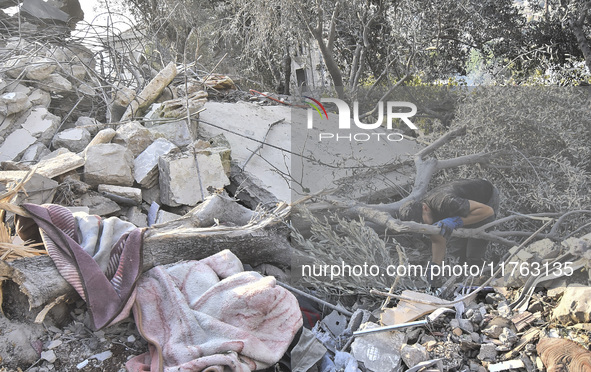 Rescuers search for survivors at the site of an Israeli airstrike that targets the village of Almat north of Beirut, Lebanon, on November 10...