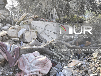 Rescuers search for survivors at the site of an Israeli airstrike that targets the village of Almat north of Beirut, Lebanon, on November 10...