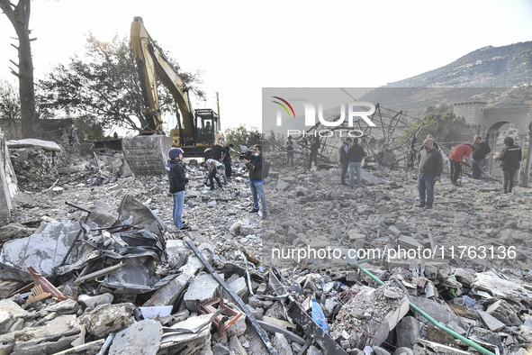 Rescuers search for survivors at the site of an Israeli airstrike that targets the village of Almat north of Beirut, Lebanon, on November 10...