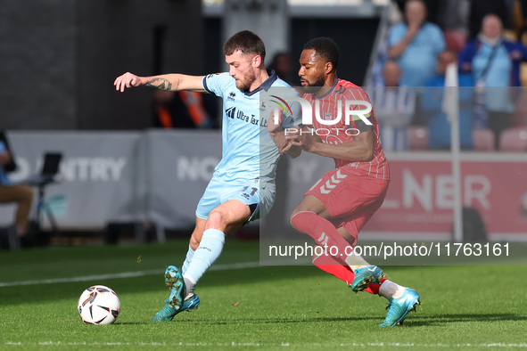 Luke Charman of Hartlepool United battles for possession with Cameron John of York City during the Vanarama National League match between Yo...