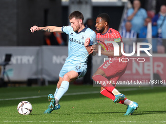 Luke Charman of Hartlepool United battles for possession with Cameron John of York City during the Vanarama National League match between Yo...