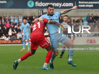 Luke Charman of Hartlepool United competes with York City's Cameron John during the Vanarama National League match between York City and Har...