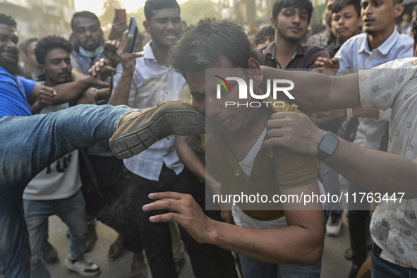 Students from anti-discrimination movements and Bangladesh Nationalist Party activists attack an Awami League supporter in Dhaka, Bangladesh...