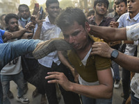 Students from anti-discrimination movements and Bangladesh Nationalist Party activists attack an Awami League supporter in Dhaka, Bangladesh...