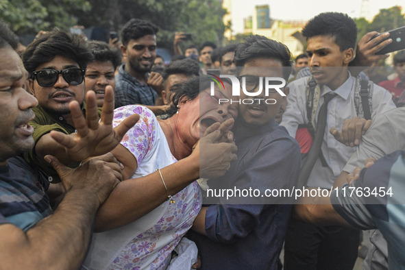 Students from anti-discrimination movements and Bangladesh Nationalist Party activists attack an Awami League woman supporter in Dhaka, Bang...