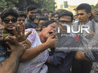 Students from anti-discrimination movements and Bangladesh Nationalist Party activists attack an Awami League woman supporter in Dhaka, Bang...