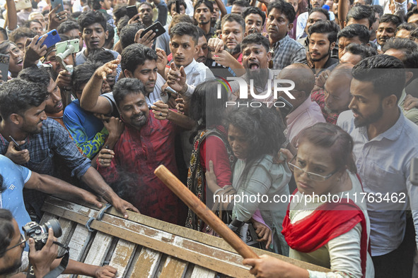 Students from anti-discrimination movements and Bangladesh Nationalist Party activists attack an Awami League woman supporter in Dhaka, Bang...