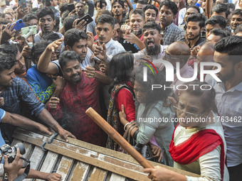 Students from anti-discrimination movements and Bangladesh Nationalist Party activists attack an Awami League woman supporter in Dhaka, Bang...