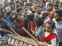 Students from anti-discrimination movements and Bangladesh Nationalist Party activists attack an Awami League woman supporter in Dhaka, Bang...