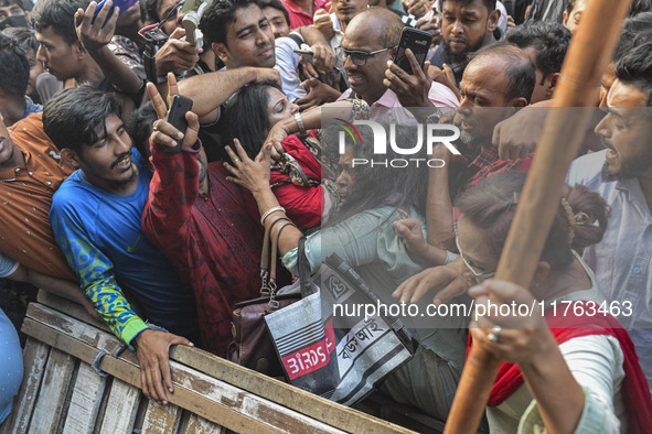 Students from anti-discrimination movements and Bangladesh Nationalist Party activists attack an Awami League woman supporter in Dhaka, Bang...